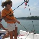 Arielle learning to trim the jib sheet.